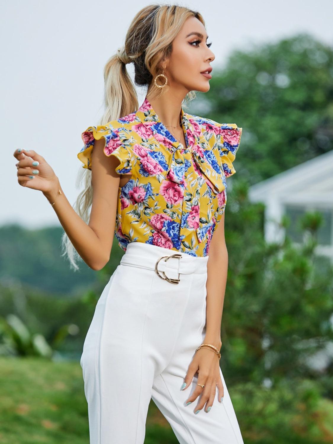 a woman in a yellow top and white pants