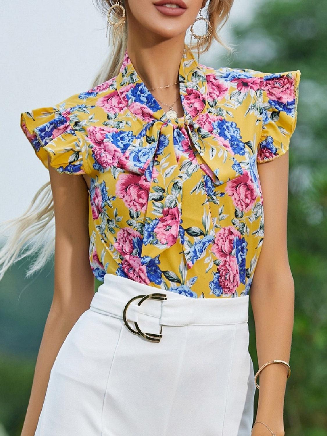 a woman wearing a yellow floral shirt and white skirt
