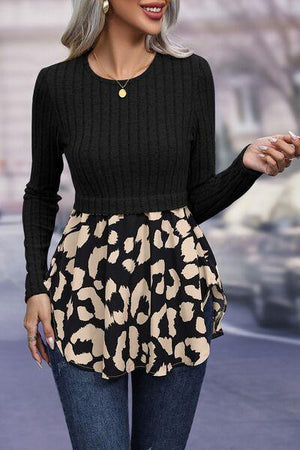 a woman in a black sweater and a leopard print skirt