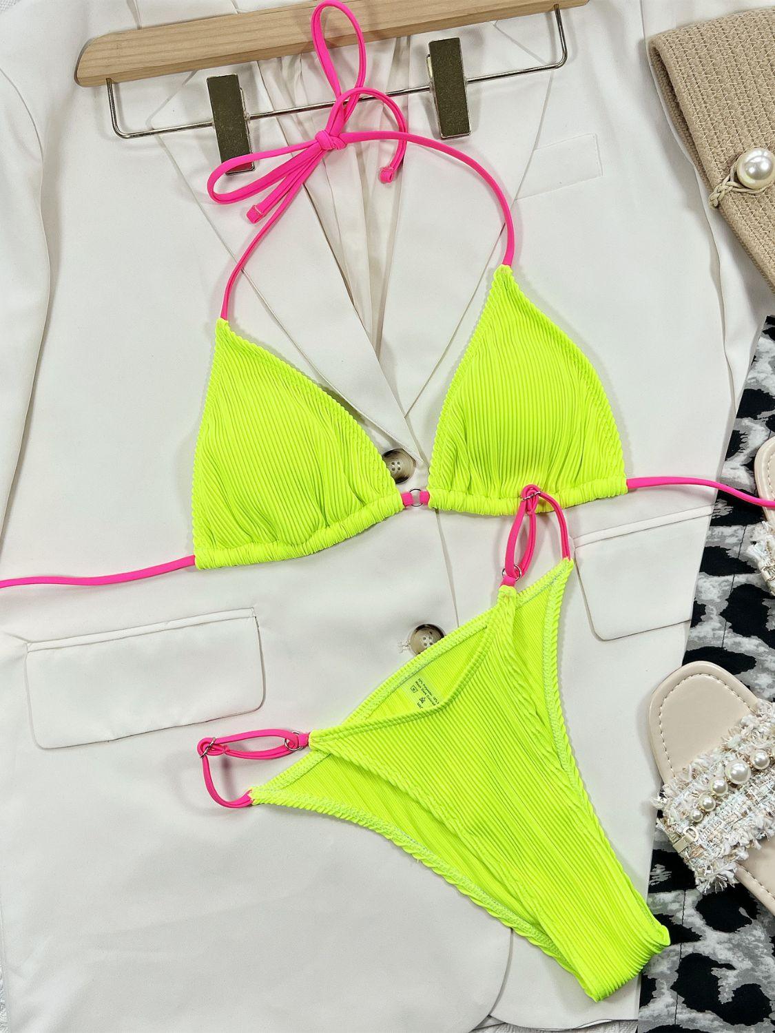 a pair of neon yellow bikinisuits on a hanger