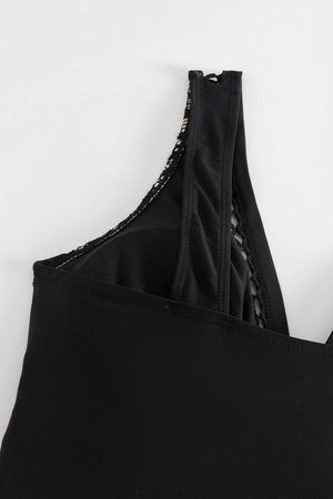 a close up of a black sports bra with zippers