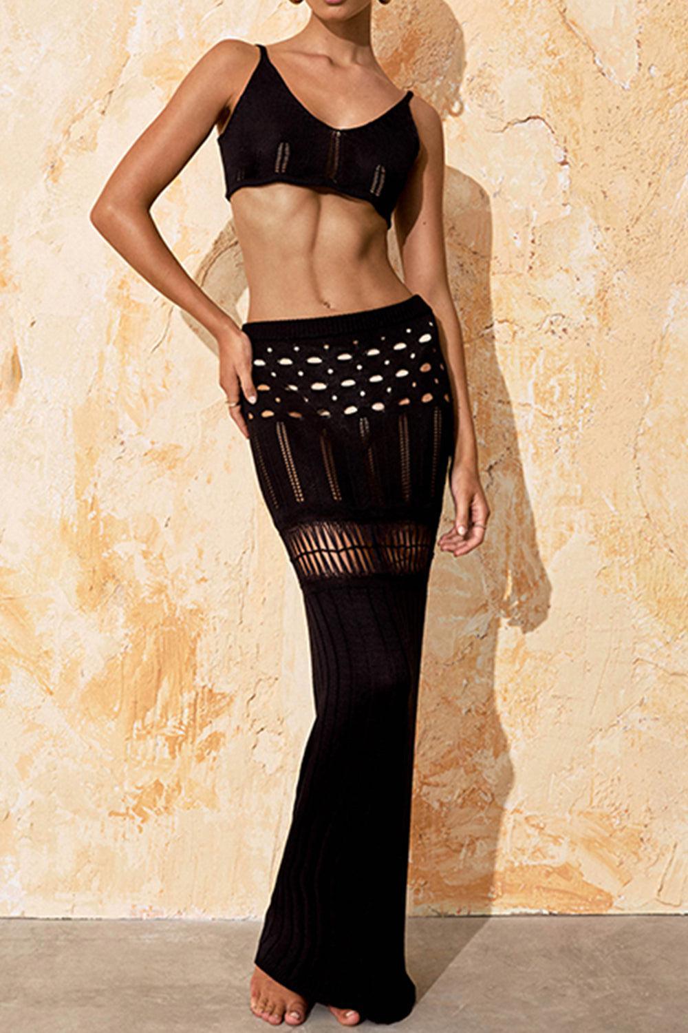 a woman in a black bikini top and skirt