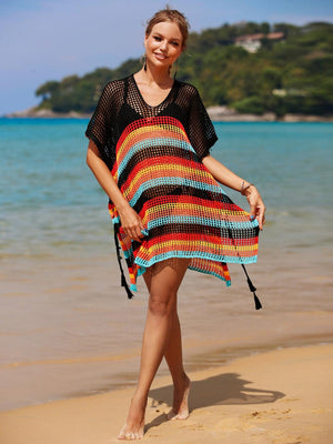 a woman standing on a beach next to the ocean