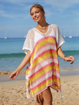 a woman standing on top of a sandy beach