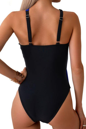 a woman wearing a black one piece swimsuit