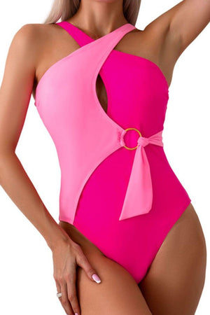 a woman in a pink one piece swimsuit