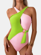 a woman in a pink and green one piece swimsuit