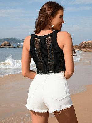 a woman standing on a beach next to the ocean