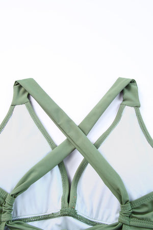 a green bra with white bra straps on a white background