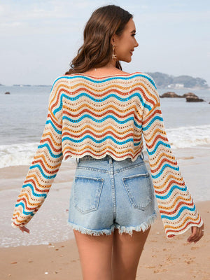 a woman standing on a beach next to the ocean