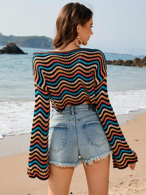 a woman standing on a beach next to the ocean