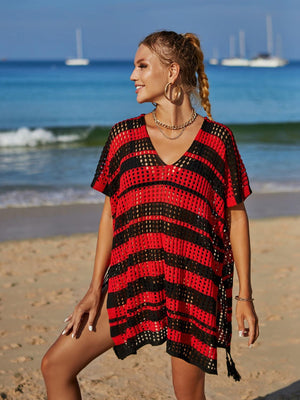 a woman standing on a beach next to the ocean