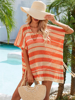 a woman in an orange and white crochet cover up