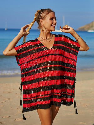 a woman walking on a beach holding a piece of food