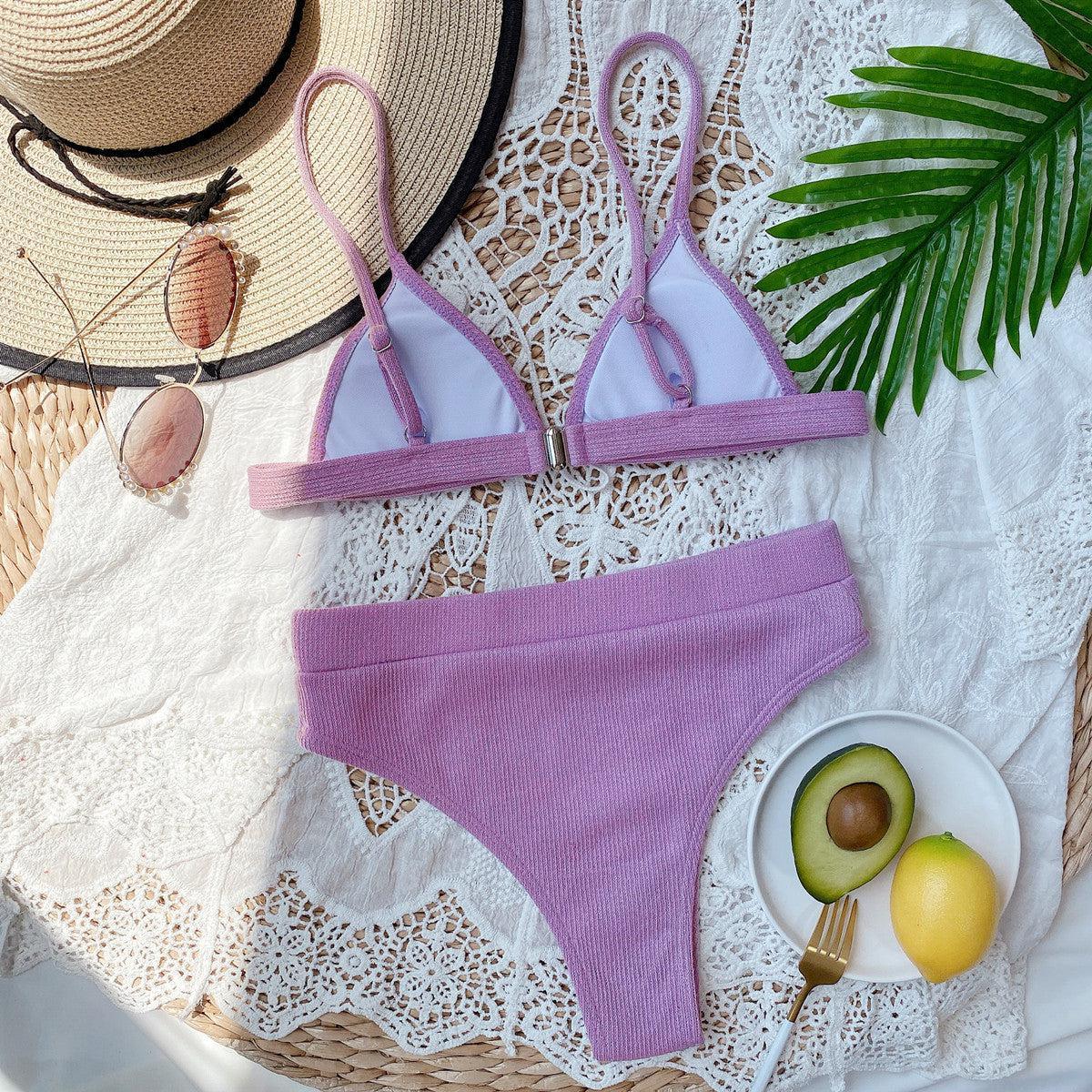 a woman's bikinisuit and hat on a table