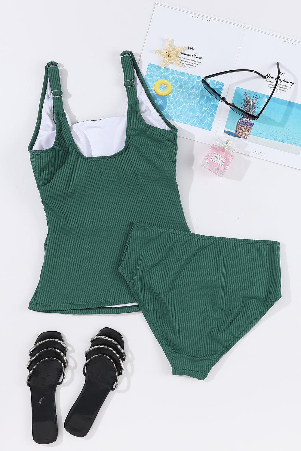 a women's swimsuit and sandals are laid out on a white surface