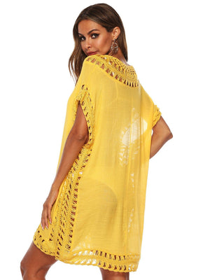 a woman wearing a yellow dress with crochet detailing