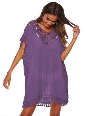 a woman wearing a purple dress with crochet details