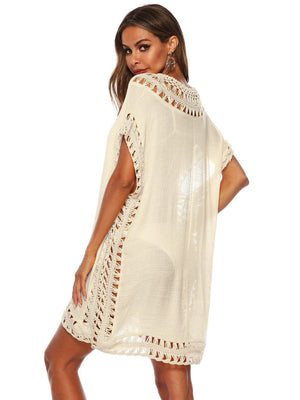 a woman wearing a white crochet cover up