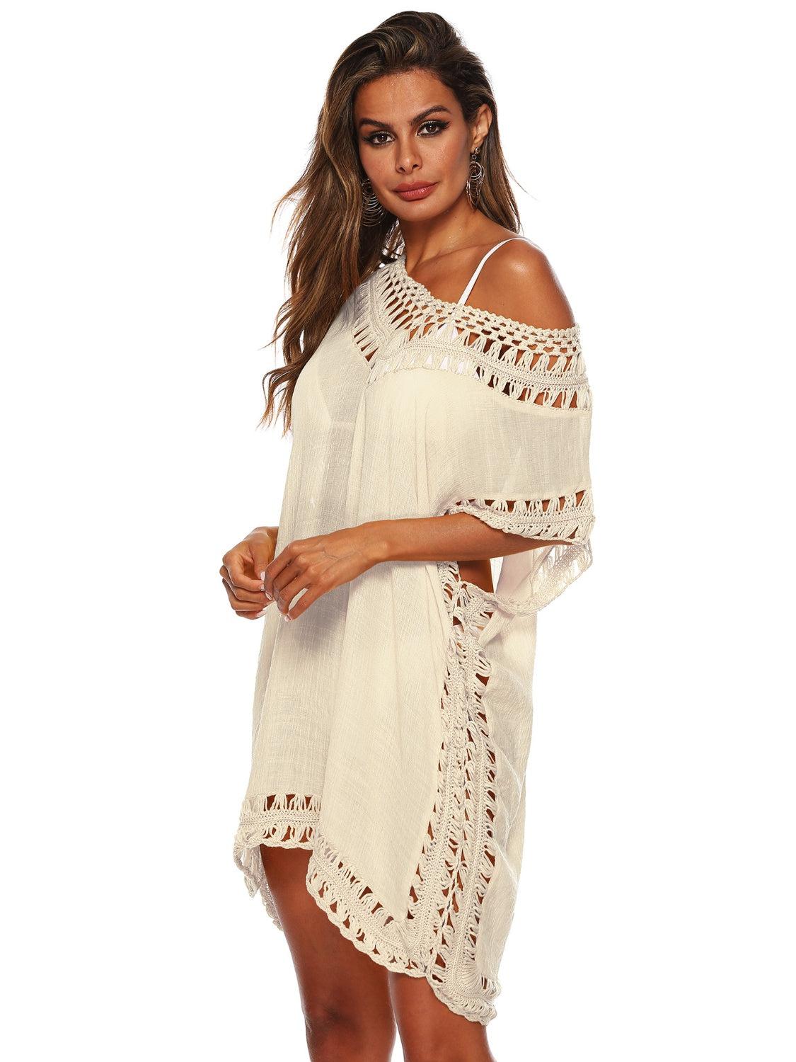 a woman wearing a white cover up with crochet