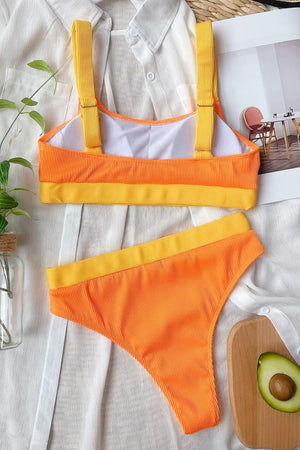 a woman's orange and yellow bikinisuit with an avocado