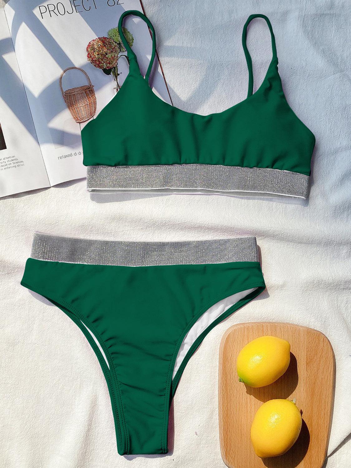 a green bikini top and two lemons on a bed