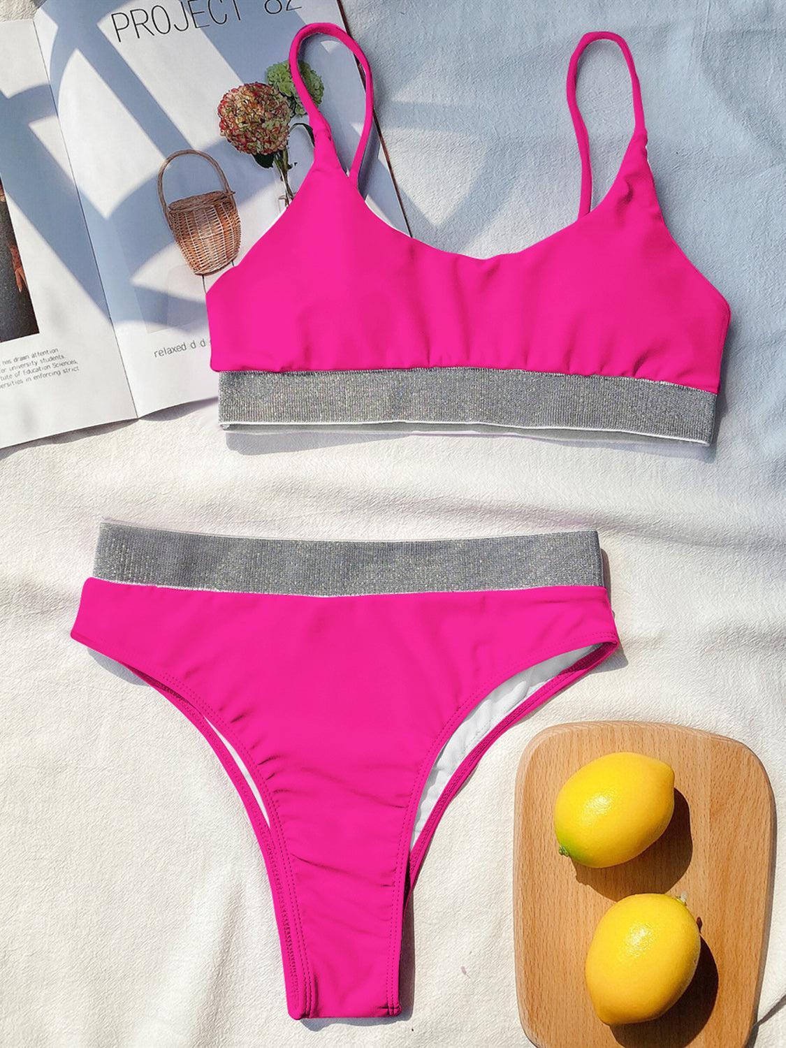 a woman's pink and grey bikinisuit next to a plate of lemons