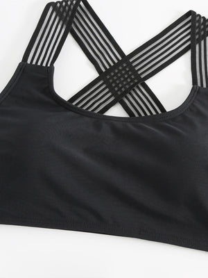 a black sports bra top with a cross back