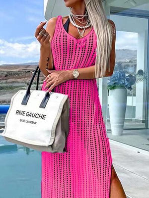 a woman in a bright pink dress holding a white bag