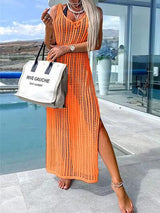 a woman in an orange dress holding a white bag
