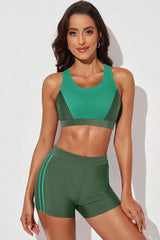 a woman in a green sports bra top and shorts