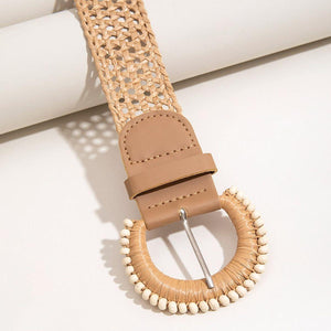 a brown belt with a white beaded buckle