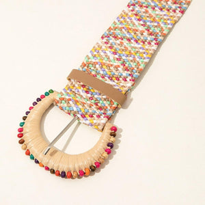 a colorful bracelet with a wooden ring on a white surface
