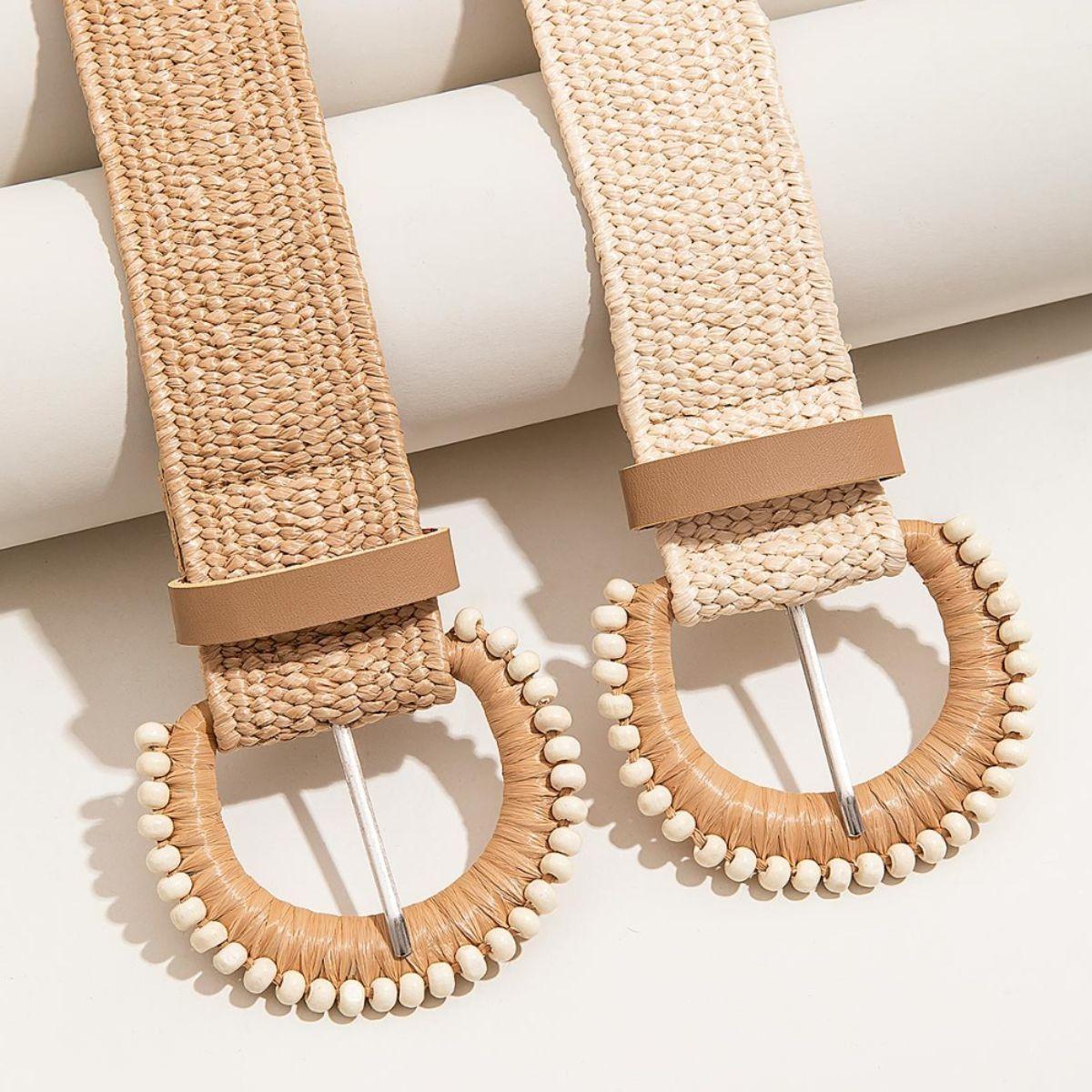 a pair of wooden hoop earrings on a white surface