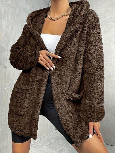 a woman wearing a brown teddy bear coat