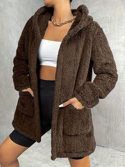 a woman wearing a brown teddy bear coat