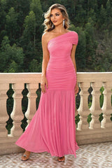 a woman in a pink dress standing on a balcony