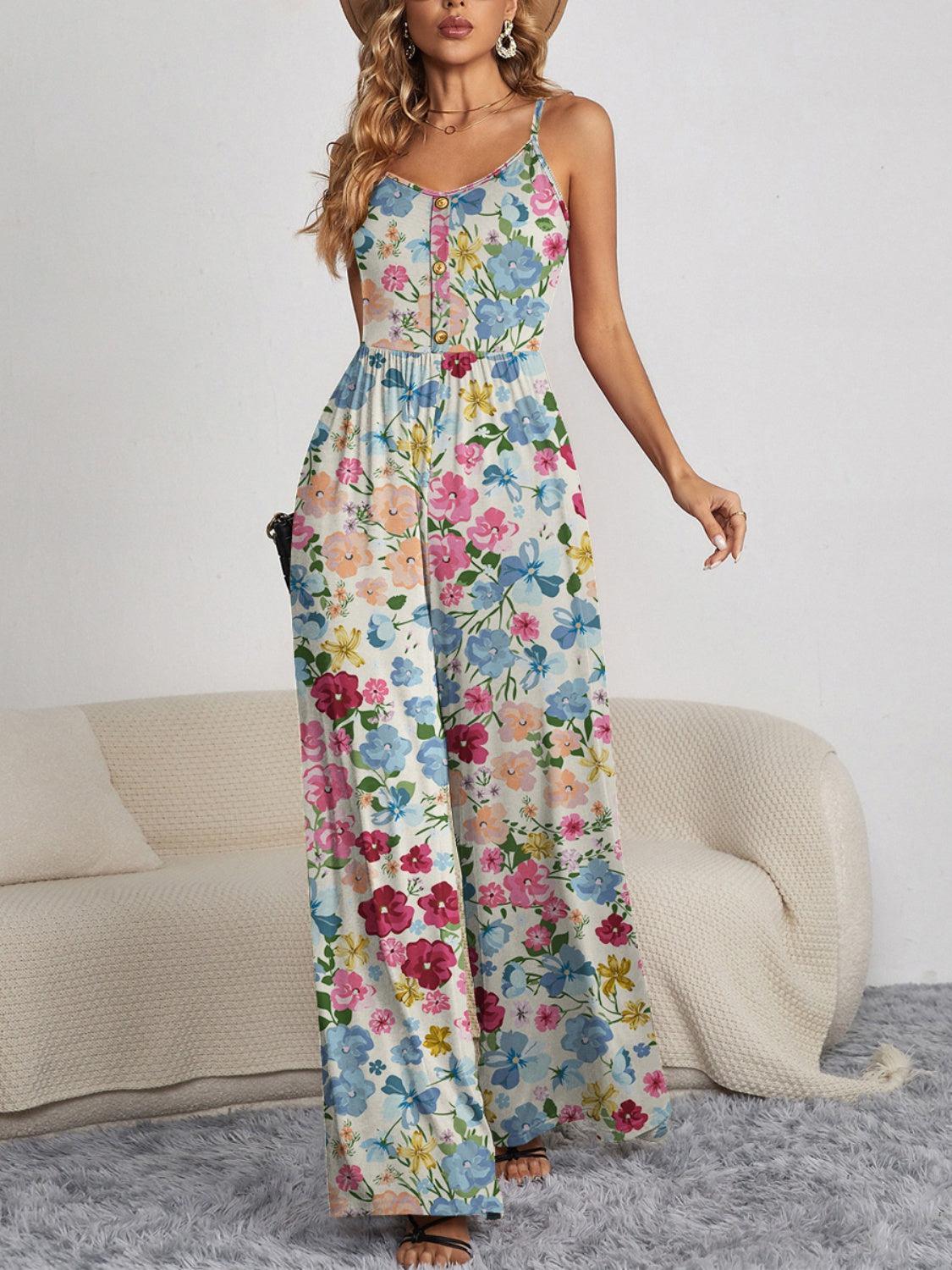a woman in a floral print jumpsuit posing for a picture