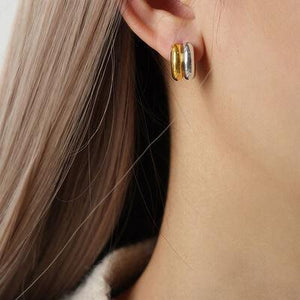 a close up of a person wearing a pair of earrings