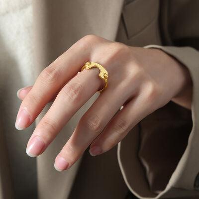 a woman's hand with a gold ring on it