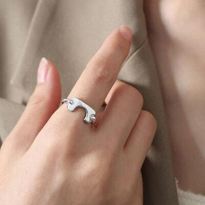 a woman wearing a ring with a knife on it