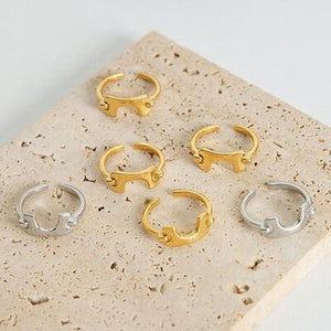 five pairs of gold and silver rings on a white surface