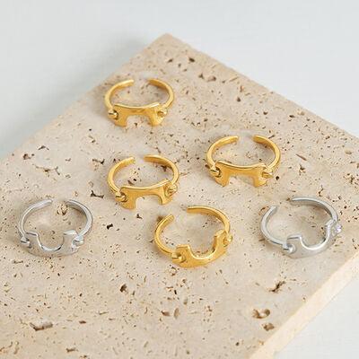 five pairs of gold and silver rings on a white surface