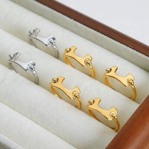 four pairs of gold and silver rings in a wooden box