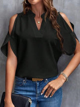 a woman wearing a black blouse and jeans