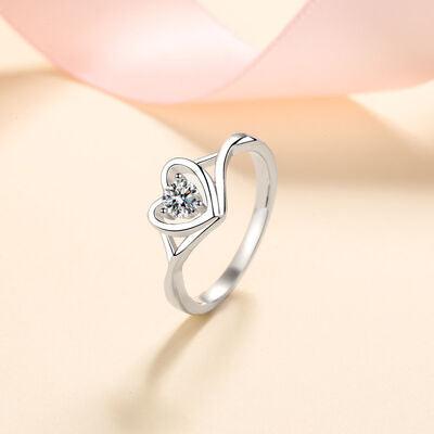 a heart shaped ring with a diamond in the middle