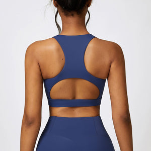 the back of a woman wearing a blue sports bra