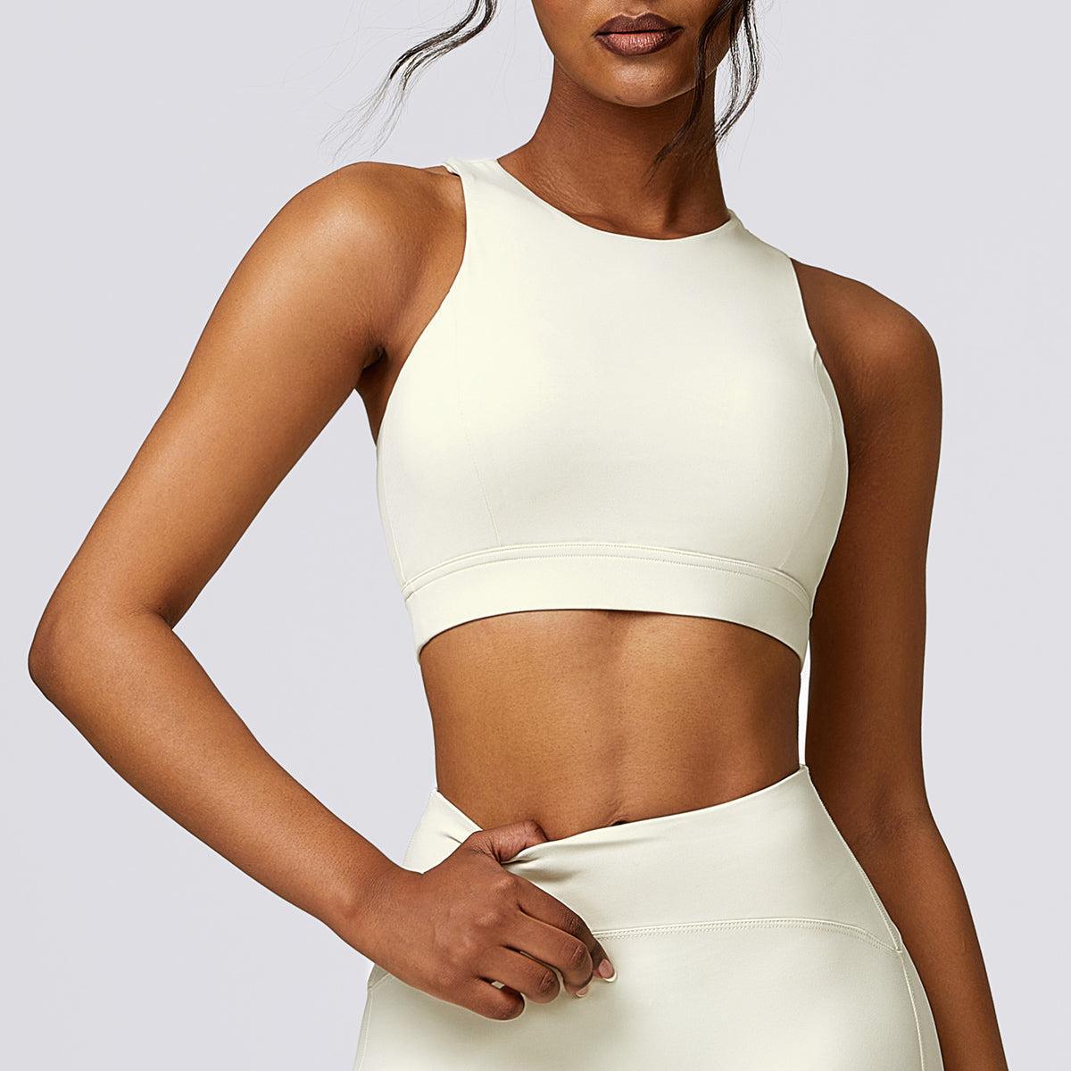 a woman wearing a white crop top and skirt