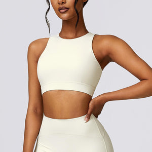 a woman in a white crop top and skirt