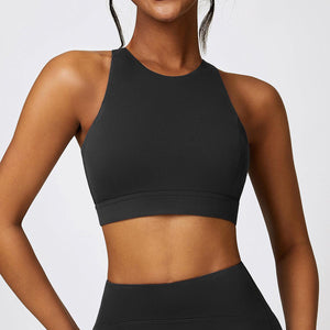 a woman wearing a black sports bra top